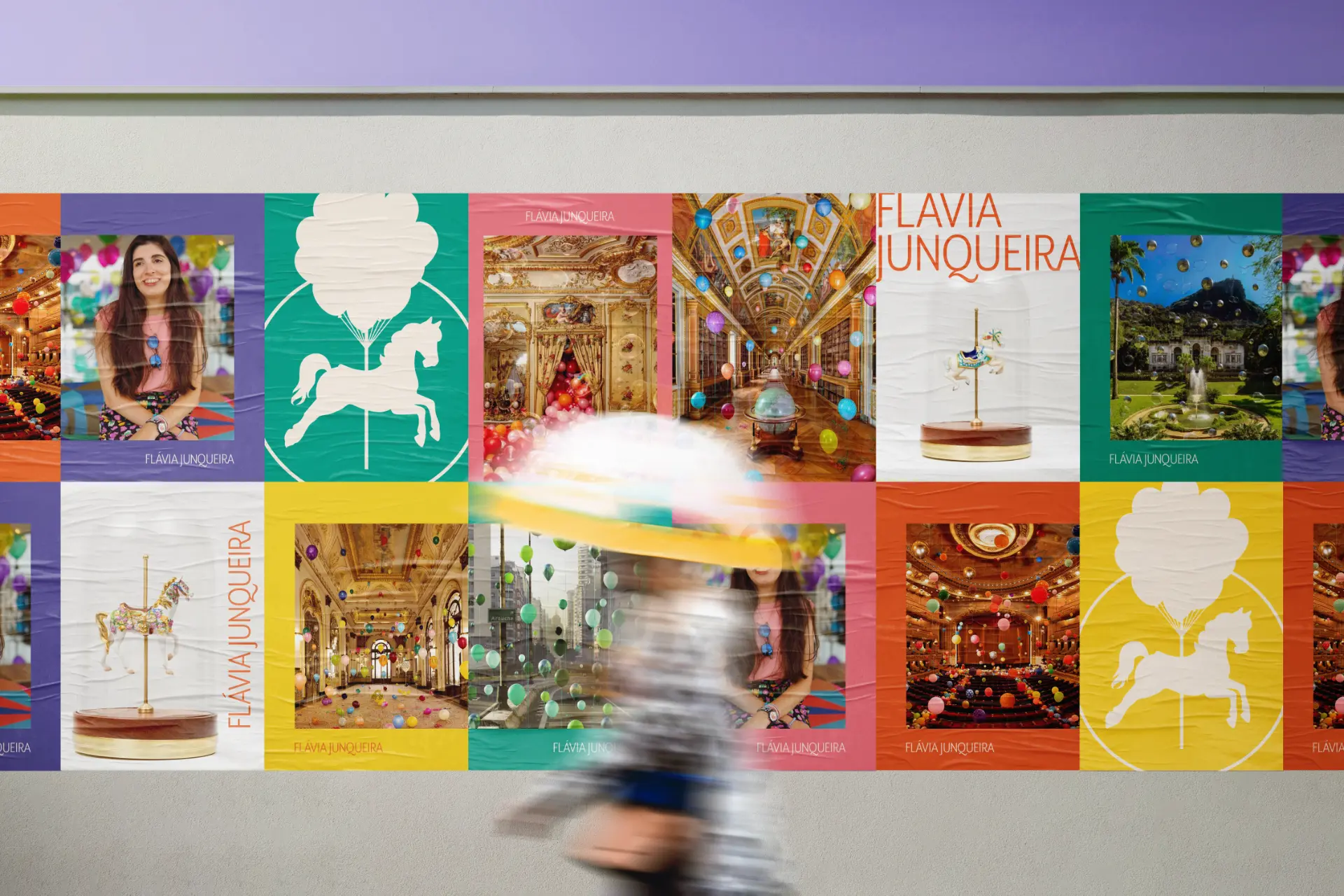 Parede de cartazes com a nova identidade de Flávia Junqueira e obras da artista, com uma pessoa passando em frente